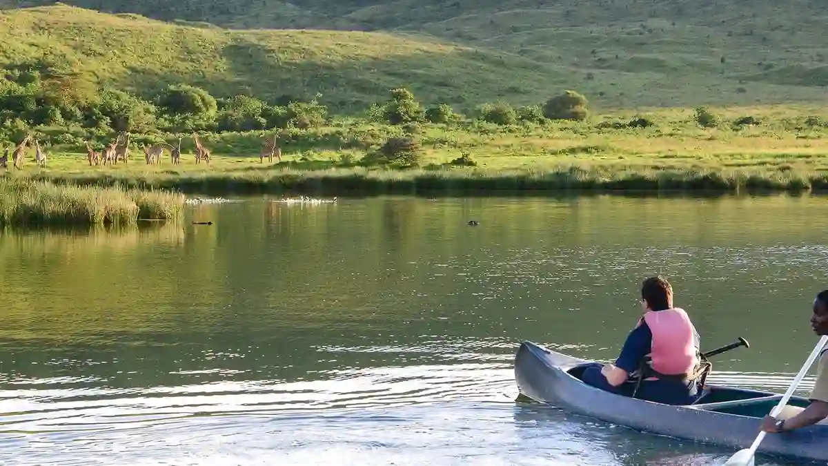 A serene moment of canoeing at Hatari Lodge, Momella Lake, showcasing the Best Time to Visit Arusha National Park.