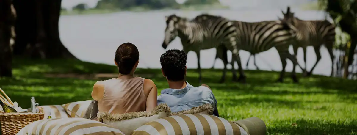 A romantic couple enjoying a luxury honeymoon safaris amidst the stunning landscapes of Tanzania.