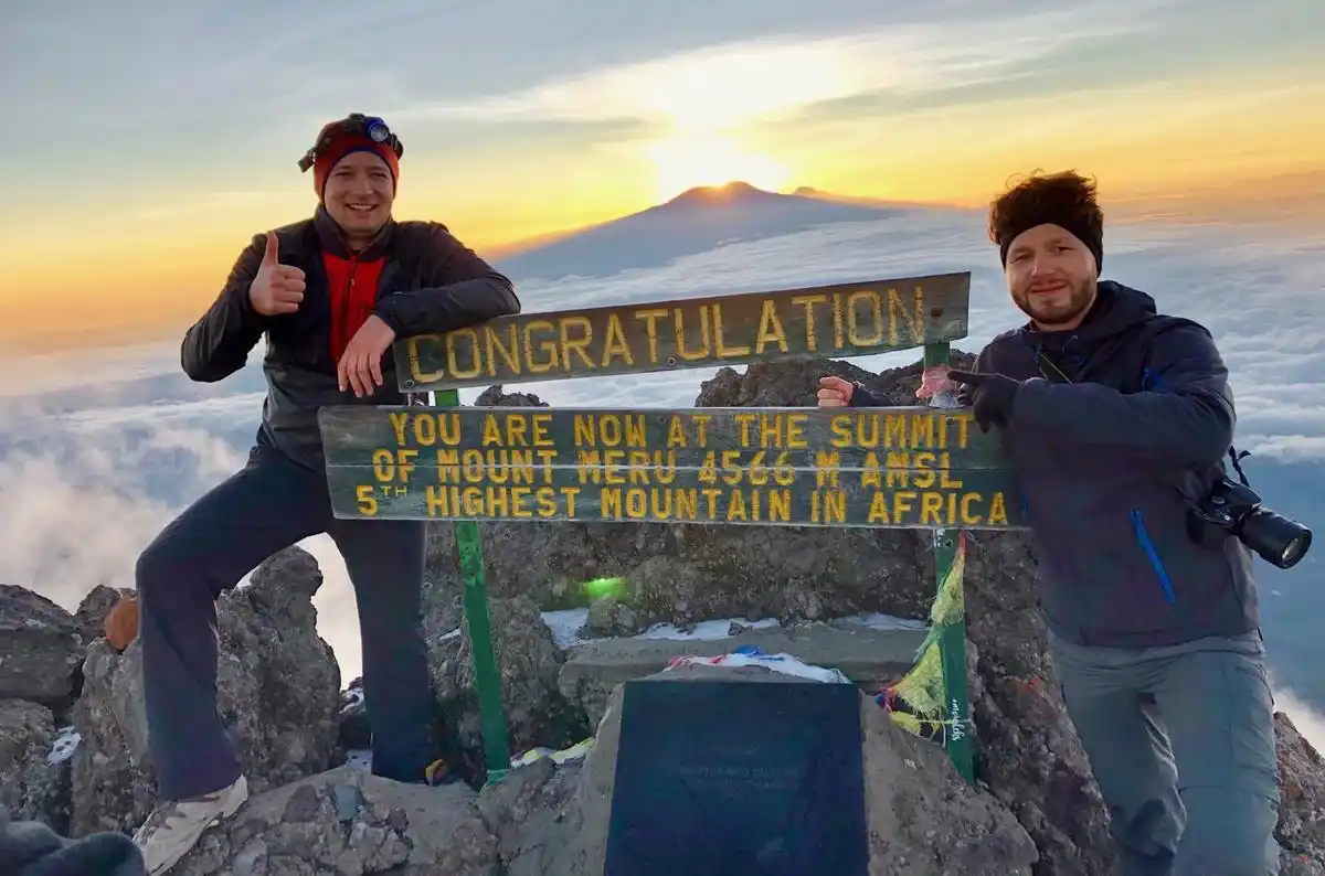 Verified hikers celebrate at the top of Mount Meru - essential Mt Meru climbing tips