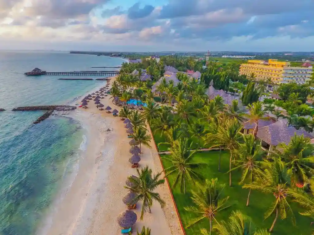 A serene view of Tanzanian coastal rentals along the white sand beaches of Zanzibar, Tanzania.
