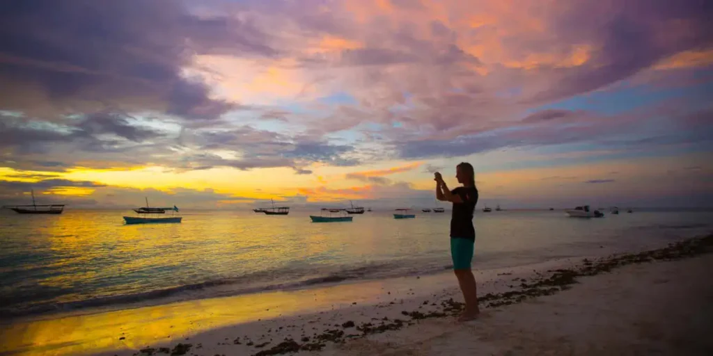 A tranquil beach scene with palm trees and turquoise waters, representing Nungwi Beach Tours.
