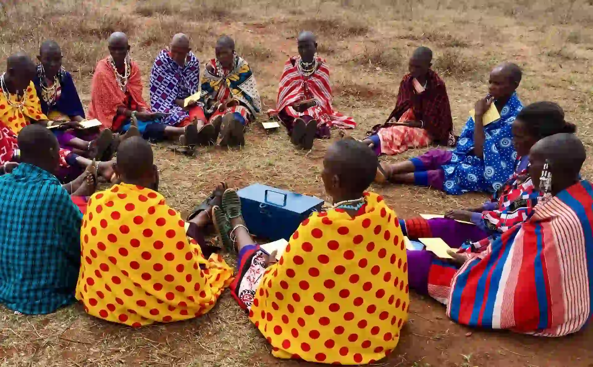 A group of tourists interacting with Maasai locals during Tarangire safaris, fostering cultural exchange and community connection.
