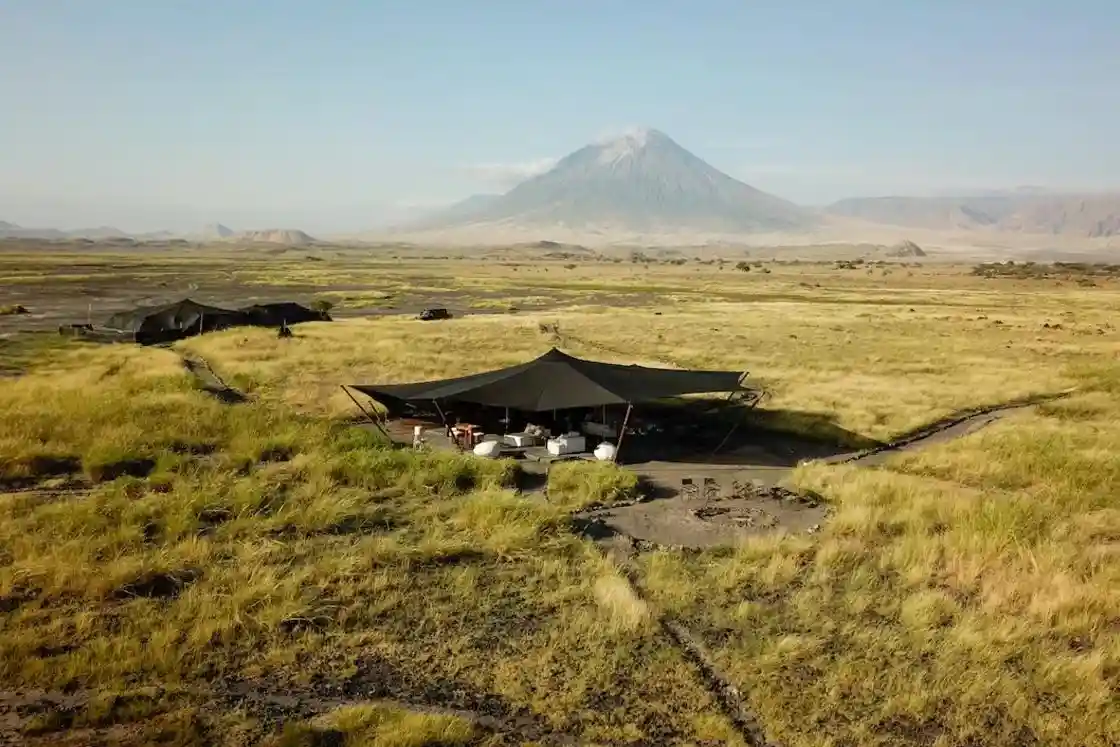 Aerial view of Lengai Camp, Oldoinyo Lengai Mountain, and Lake Natron, showcasing accommodations near Mt Oldoinyo Lengai.
