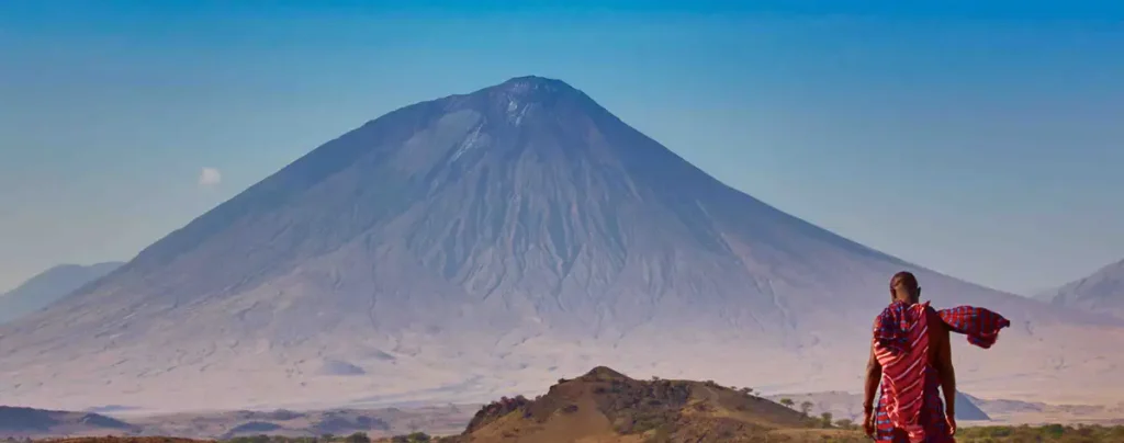 Majestic Encounter: African Safaris - Lion in Tanzania's Wilderness Oldoinyo Lengai trekking adventure - Experience the breathtaking beauty of the mountain slopes as we ascend towards the summit, unveiling the secrets of this sacred landscape.