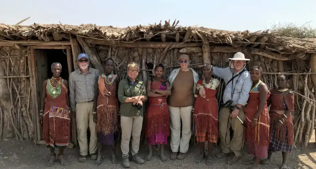 A tourist engaging with Maasai villagers in Tanzania as part of Tanzania Cultural tourism
