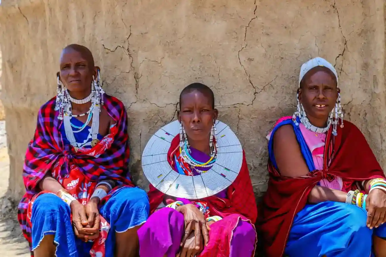 A group of Tanzania Maasai women adorned in traditional attire, showcasing the vibrant Maasai culture.