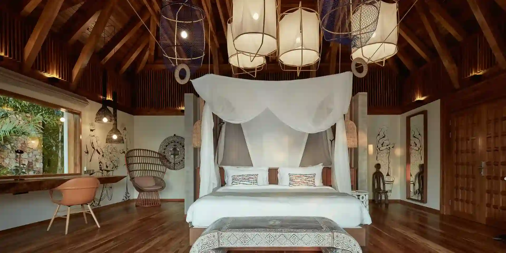 Majestic Encounter: African Safaris - Lion in Tanzania's Wilderness A serene ocean-front bedroom villa showcasing luxury accommodation at Zuri Zanzibar, with modern amenities and breathtaking views.