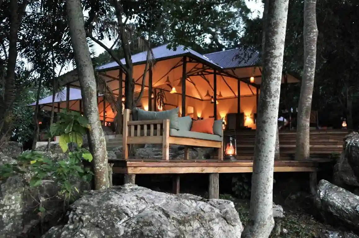 A serene scene of Rubondo Island Camp nestled amidst the natural beauty of Kitulo National Park, offering luxurious accommodation options.