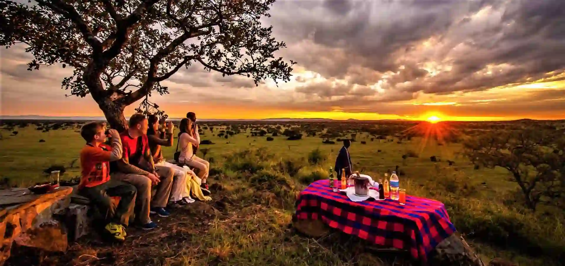 A mesmerizing sunset paints the sky in warm hues over Kitulo National Park, offering a tranquil camping experience amidst nature's beauty. Kitulo National Park travel advice.