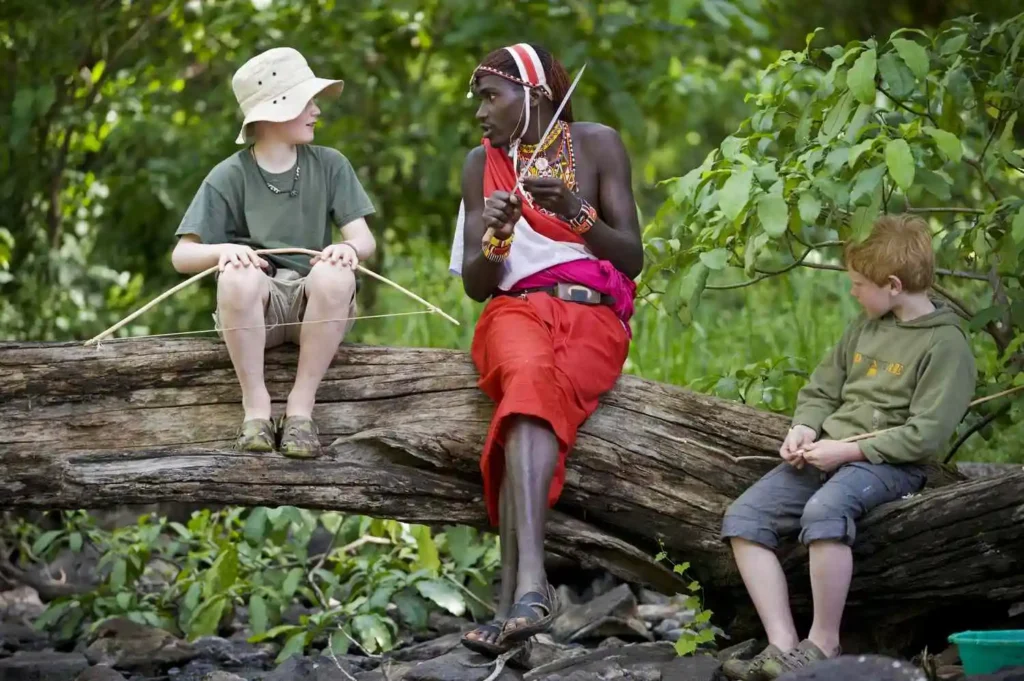 Swahili words come to life as a Maasai chats with two foreign kids during a Tanzania safari